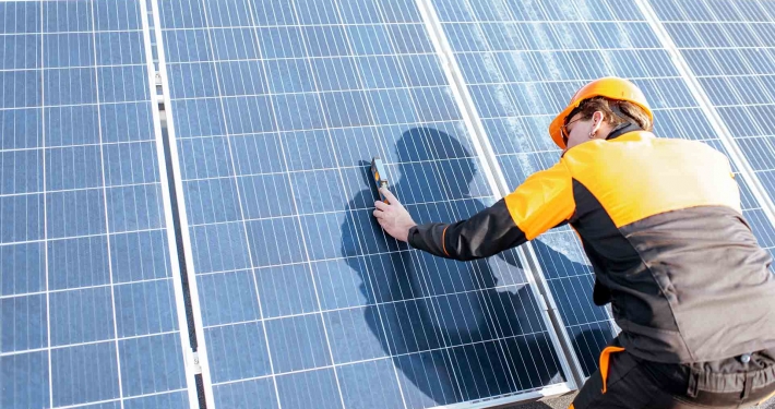 Worker doing maintenance on a solar array